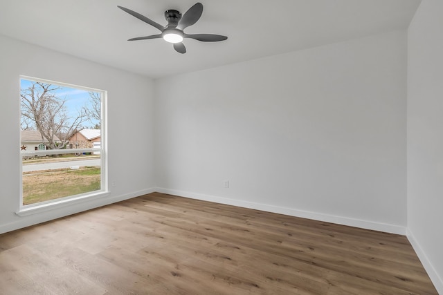 empty room with ceiling fan and hardwood / wood-style floors