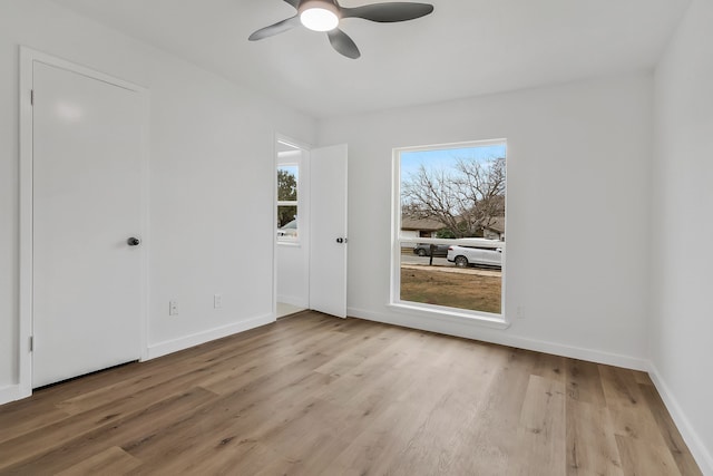 unfurnished room with ceiling fan, light hardwood / wood-style floors, and a healthy amount of sunlight