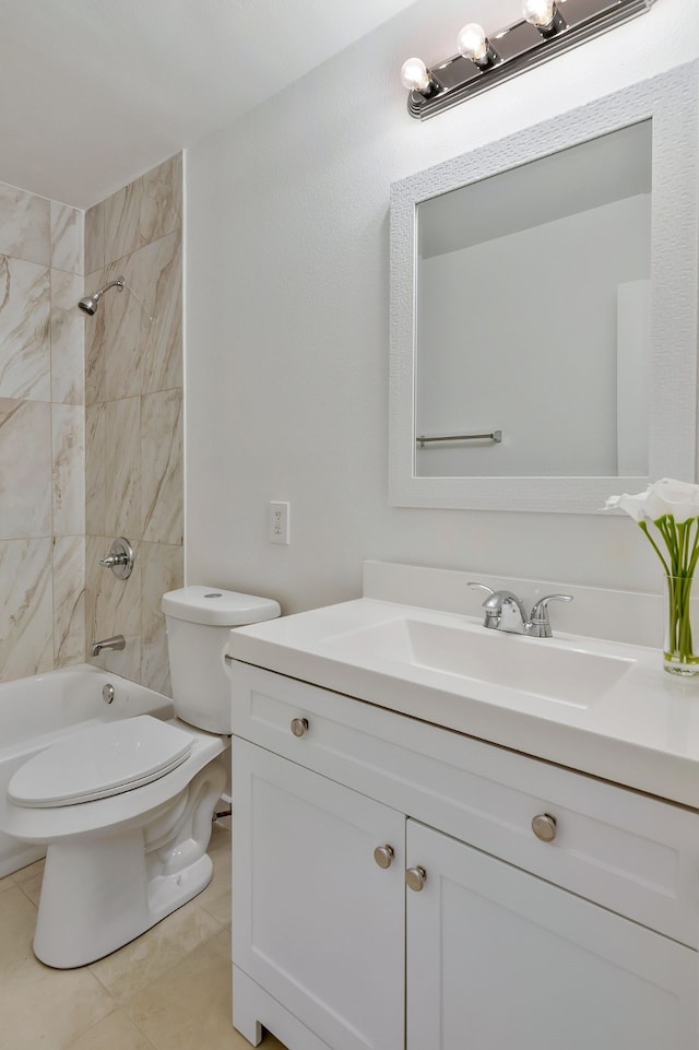 full bathroom featuring tiled shower / bath, vanity, toilet, and tile patterned floors