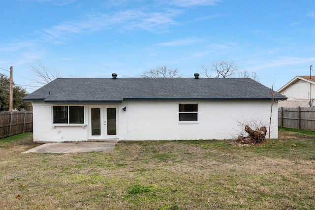 back of property featuring french doors, a patio area, and a lawn