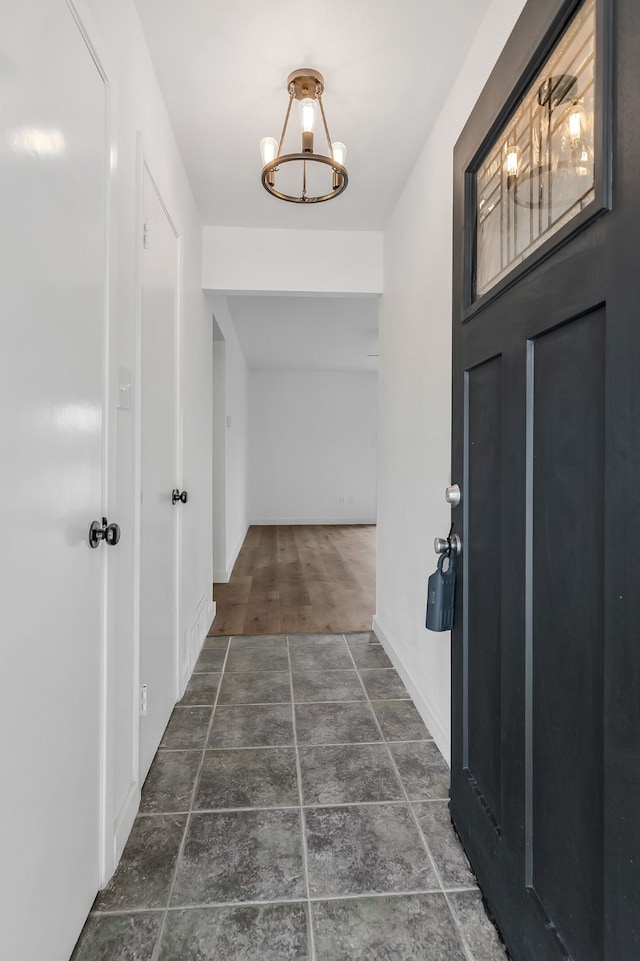 foyer entrance featuring an inviting chandelier