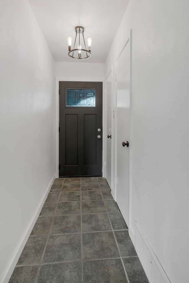 entryway with a chandelier