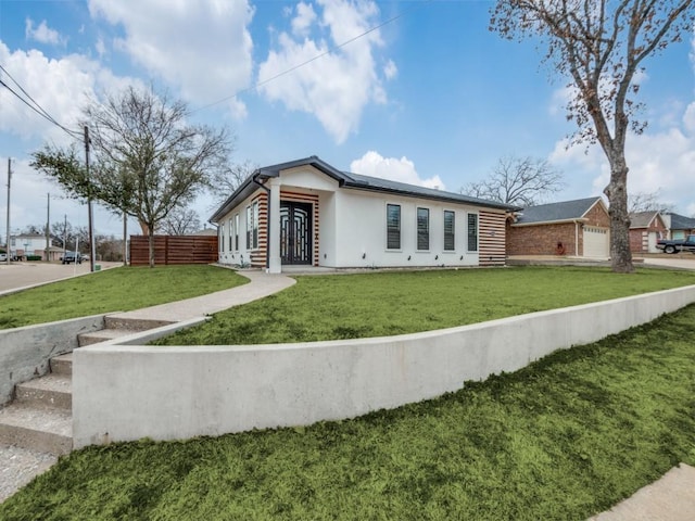 view of front of house with a garage and a front yard