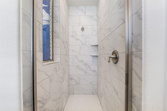 bathroom with tiled shower