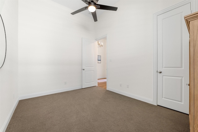 empty room with ceiling fan and carpet