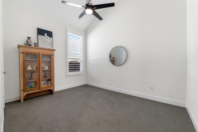 unfurnished room featuring vaulted ceiling, ceiling fan, and dark carpet