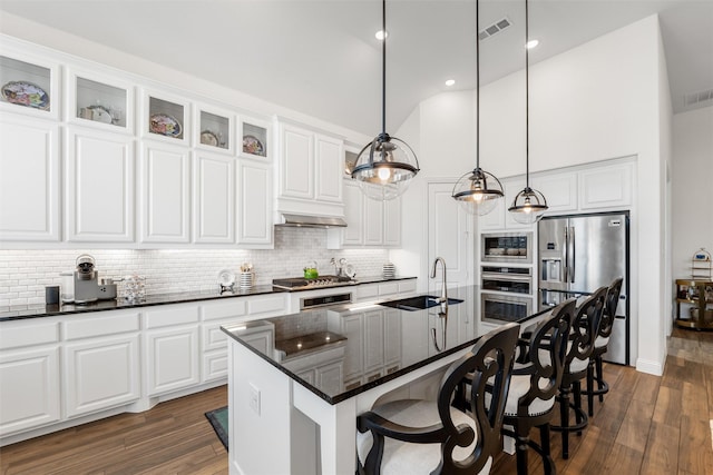 kitchen featuring appliances with stainless steel finishes, sink, a center island with sink, and white cabinets