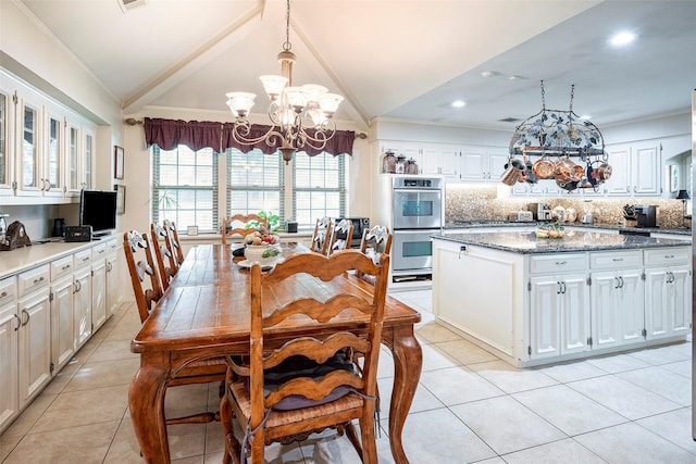 dining area with light tile patterned flooring, lofted ceiling, crown molding, and a chandelier