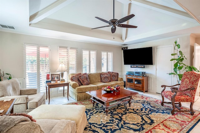 living room with crown molding, light tile patterned floors, a tray ceiling, beamed ceiling, and ceiling fan