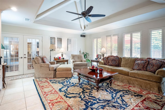 living room with crown molding, a healthy amount of sunlight, light tile patterned floors, and french doors