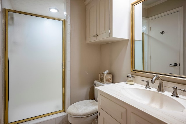 bathroom with an enclosed shower, vanity, and toilet