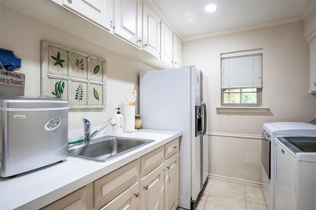 laundry area featuring sink, light tile patterned floors, washer and clothes dryer, and ornamental molding