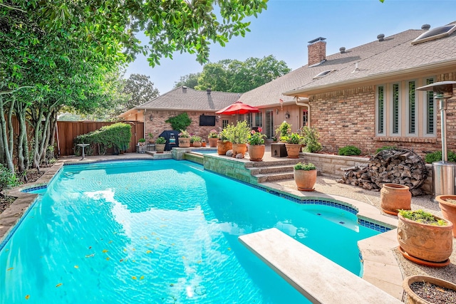 view of pool with a diving board