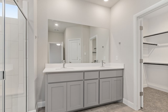 bathroom with vanity and a shower with shower door