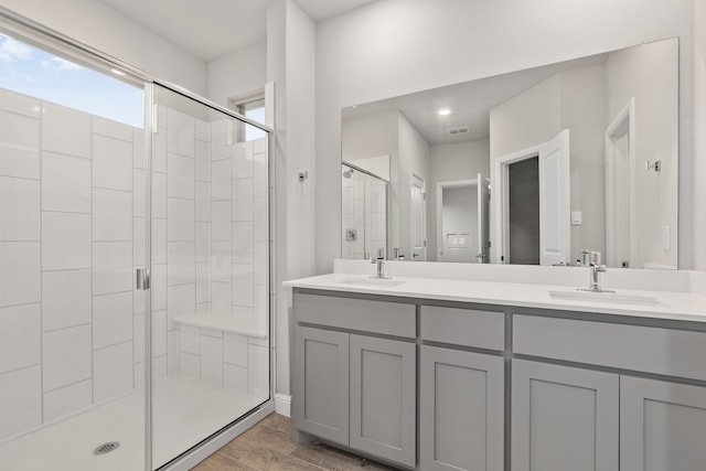 bathroom featuring vanity, a shower with shower door, and hardwood / wood-style floors