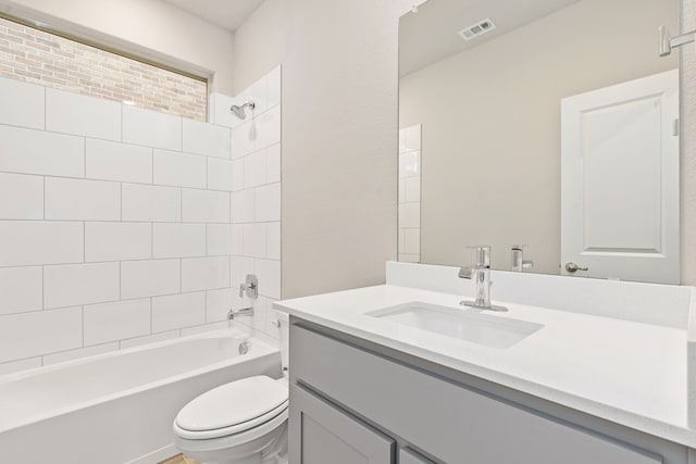 full bathroom featuring vanity, toilet, and tiled shower / bath