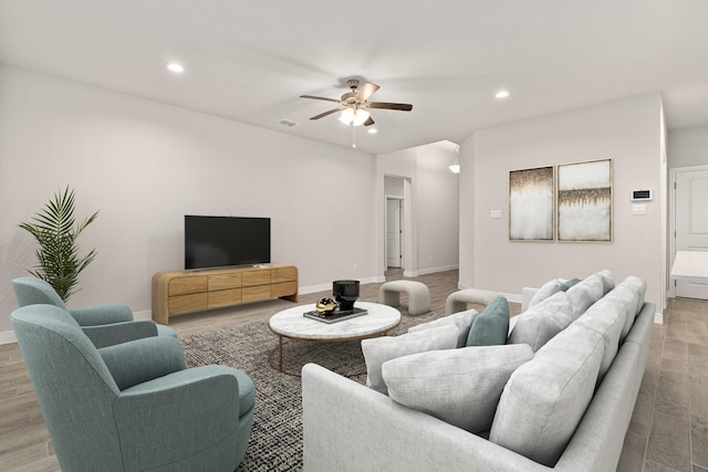 living room featuring ceiling fan and light wood-type flooring