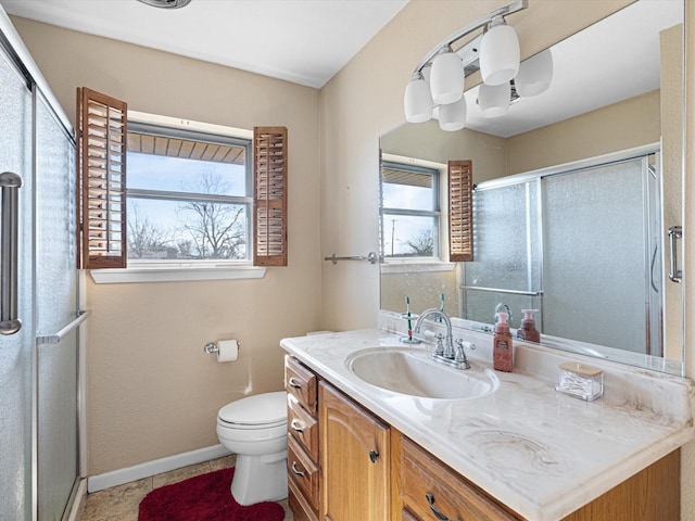 bathroom with vanity, plenty of natural light, a shower with door, and toilet