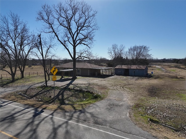 ranch-style home with a playground and a rural view