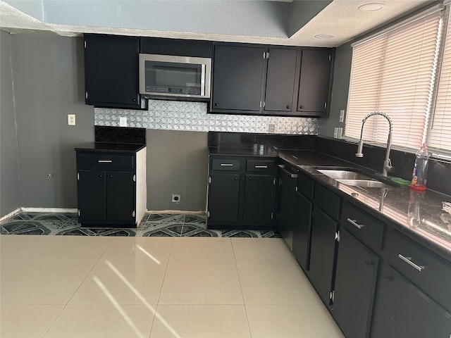 kitchen with sink, light tile patterned floors, and decorative backsplash