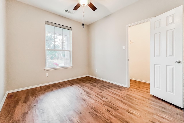 empty room featuring ceiling fan and light wood-type flooring