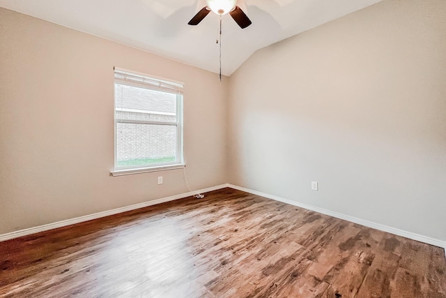 empty room with ceiling fan, lofted ceiling, and hardwood / wood-style floors