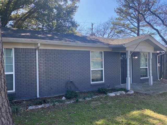 view of side of property with a lawn