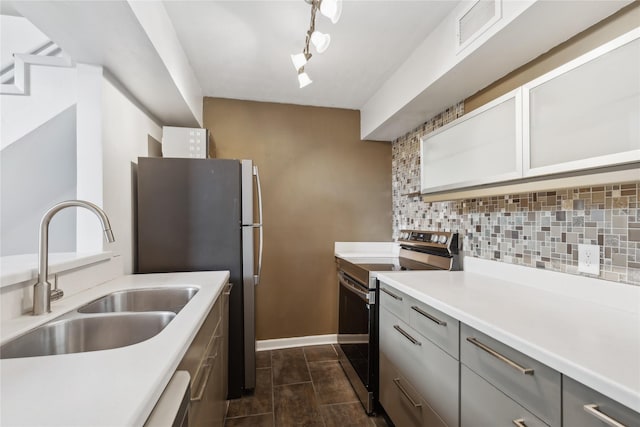 kitchen with tasteful backsplash, sink, gray cabinets, and appliances with stainless steel finishes