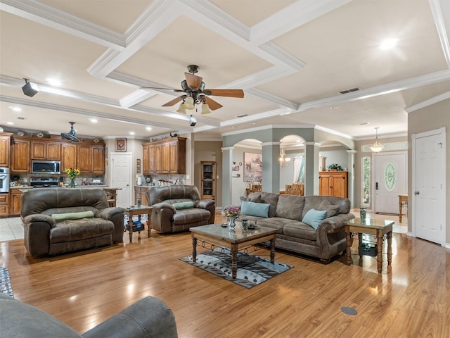 living room featuring ornamental molding, coffered ceiling, ceiling fan, beam ceiling, and light hardwood / wood-style flooring