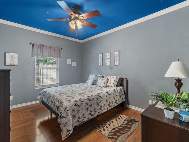 bedroom with ornamental molding, hardwood / wood-style floors, and ceiling fan