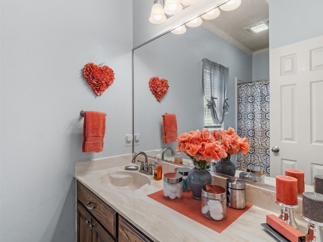 bathroom with vanity and ornamental molding