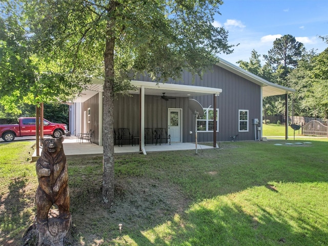 back of property with ceiling fan, a patio area, and a lawn