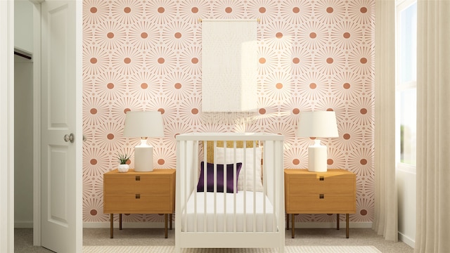 bedroom with a nursery area and carpet