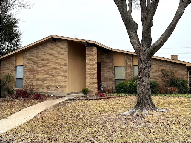 mid-century modern home with brick siding