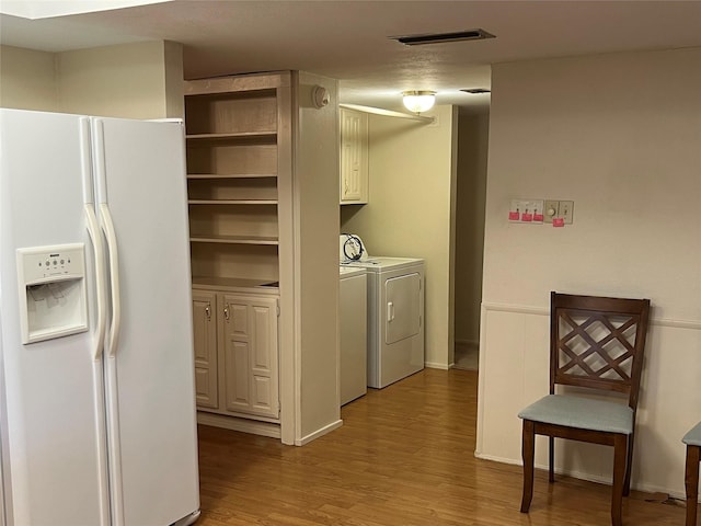 2118 Courtland Cir, Carrollton, TX 75007 - washroom with washing machine and dryer and wood finished floors