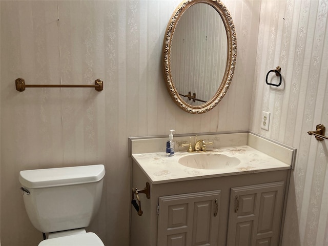 half bathroom with toilet and vanity