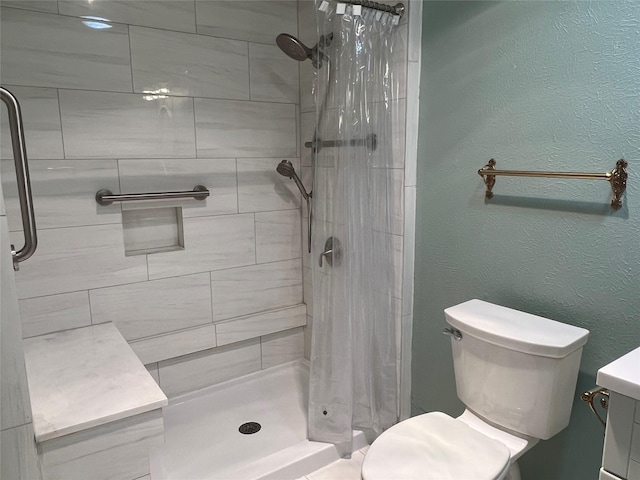 2118 Courtland Cir, Carrollton, TX 75007 - bathroom featuring a shower stall, toilet, a textured wall, and vanity