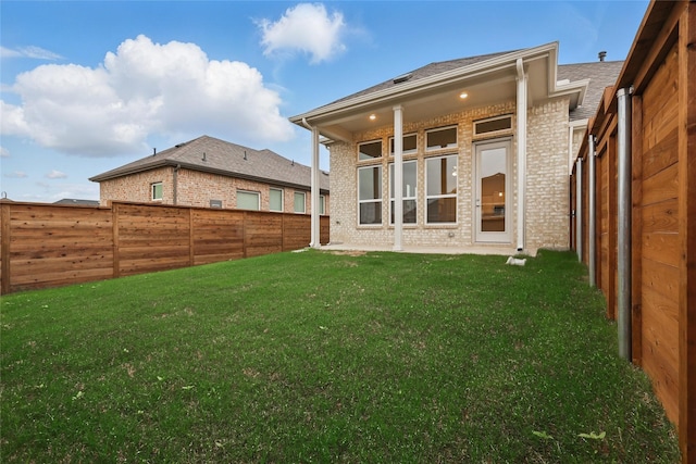 1804 Night Owl Way, Mesquite, TX 75181 - rear view of property with a fenced backyard, brick siding, and a lawn