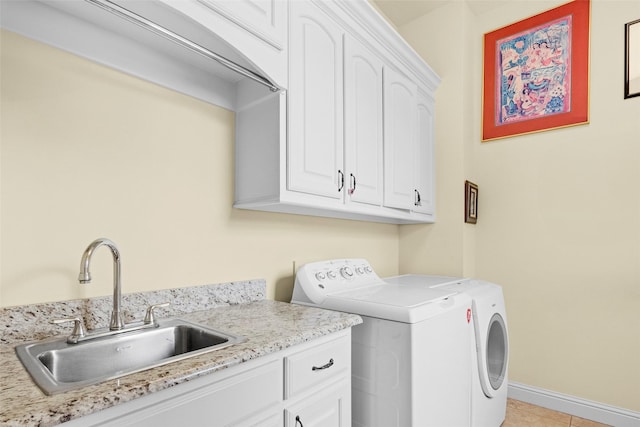 laundry room featuring cabinets, sink, light tile patterned floors, and independent washer and dryer