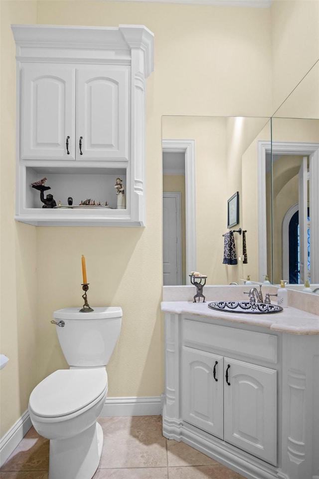 bathroom featuring vanity, tile patterned floors, and toilet