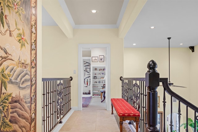 corridor with ornamental molding and light tile patterned floors