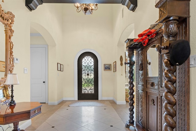 tiled entrance foyer with a high ceiling