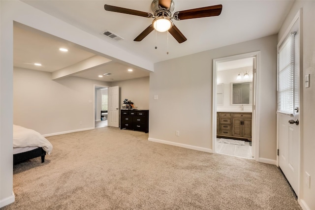 bedroom featuring carpet floors, sink, beam ceiling, and ensuite bath