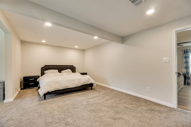 carpeted bedroom with beam ceiling