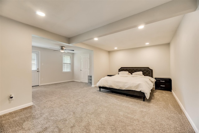 carpeted bedroom featuring ceiling fan and beam ceiling