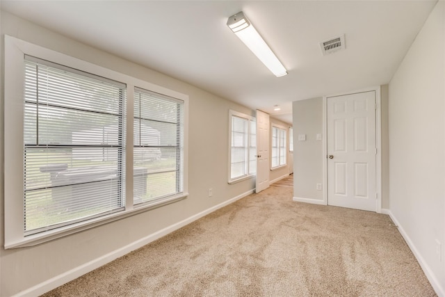 empty room featuring light carpet