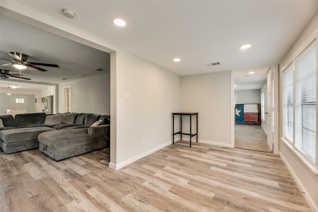 living room featuring ceiling fan and light hardwood / wood-style floors