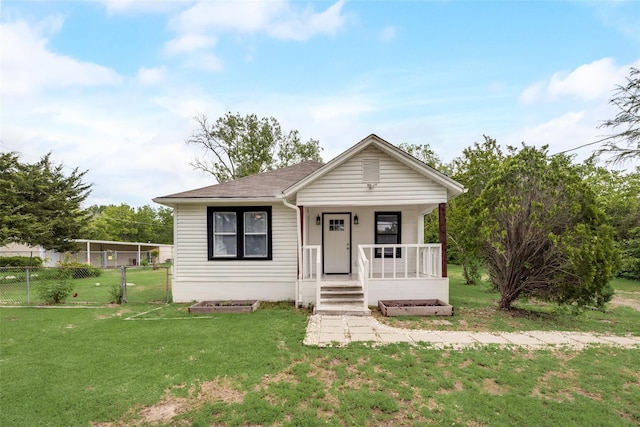 view of front of home featuring a front yard and covered porch