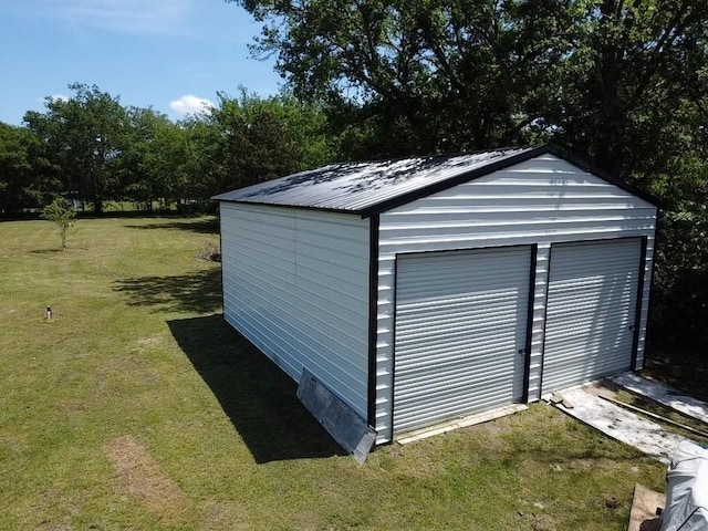 garage featuring a lawn