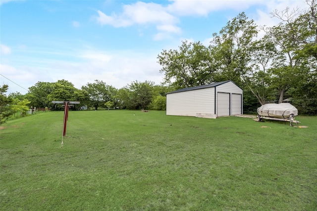 view of yard featuring an outbuilding and a garage